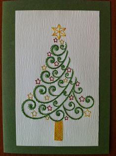 a christmas tree with stars and swirls on the bottom is made from white paper