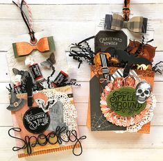 two halloween greeting cards on a white wooden surface with black and orange accents, one has a skeleton