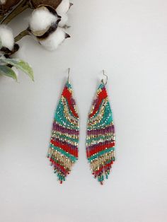 "Colorful beaded earrings, statement boho earrings, unique beaded earrings Length 5\" including ear wire Width 1\" Made with best quality Japanese seed beads and 24k gold dipped seed beads Lightweight and unique extravagant style - designed and made by Luba Ro 8 Colors used - beige, gold, silver, red, dark rose, shimmery purple, mint green and turquoise blue electric blue Select closure earwires leverbacks clip-ons for non pierced ears" Artsy Beaded Drop Earrings, Bohemian Beaded Dangling Earrings, Bohemian Beaded Dangle Earrings, Multicolor Bohemian Jewelry With Gold Beads, Bohemian Multicolor Jewelry With Gold Beads, Colorful Beaded Earrings For Summer, Colorful Beaded Summer Earrings, Beaded Bohemian Chandelier Earrings, Bohemian Beaded Chandelier Earrings