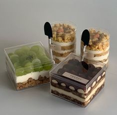 four desserts in plastic containers on a table