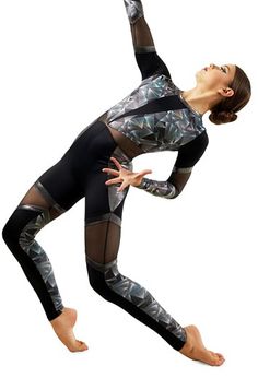 a woman in black and grey leotard doing yoga