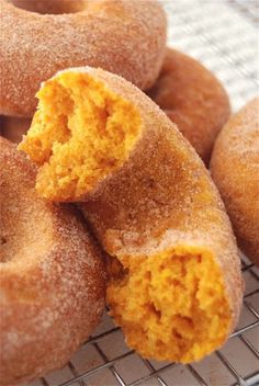 some sugared doughnuts are on a cooling rack