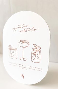 a white box with an illustration of cocktails on the front and side, in red ink