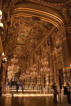 an ornately decorated hall with chandeliers and lights