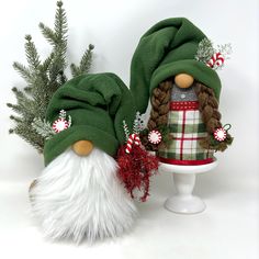 two christmas gnomes with green hats and white hair