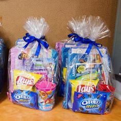 three bags filled with toys sitting on top of a table