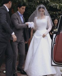 the bride is getting out of her car and ready to walk down the aisle with her father