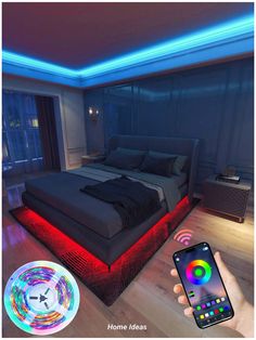 a person holding a cell phone in front of a bed with colorful lights on it