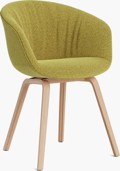 an upholstered chair with wooden legs and a green fabric seat cover on the back