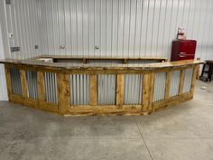 a large wooden counter sitting inside of a garage next to a red fire hydrant