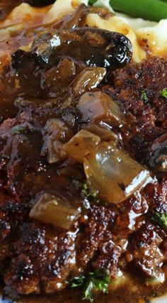 a close up of food on a plate with broccoli and meat in sauce