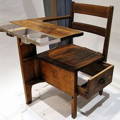 a wooden desk with a glass top and drawer on it's side, in front of a white background