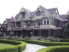 a large house with hedges in front of it