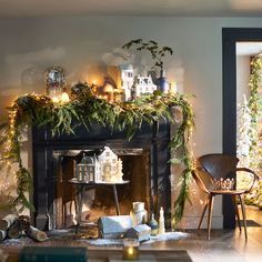 a living room decorated for christmas with greenery