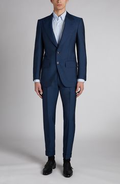 The label's impeccable tailoring shines through on this suit cut from a wool-mohair blend with an iridescent sheen and finished with mother-of-pearl buttons. Jacket has peaked lapels; five-button cuffs; chest welt pocket; front flap pockets; ticket pocket; back vent Pants have zip fly with hook-and-bar closure; adjustable waist tabs; front slant pockets; back button-welt pockets Jacket is lined 70% wool, 30% mohair Dry clean Made in Italy Designer Clothing Designer Tailored Suits With Suit Collar, Single Breasted Tailored Silk Suits, Luxury Tailored Wool Three-piece Suit, Bespoke Tailored Silk Suits, Tailored Silk Suits Timeless Style, Tailored Timeless Silk Suit, Luxury Tailored Three-piece Suit With Pressed Crease, Designer Fitted Suits With Welt Pockets, Luxury Wool Three-piece Suit For Wedding