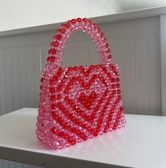 🌸 Handmade Heart-Shaped Beaded Bag: Symbol of Love and Elegance 🌸 Express your style and personality with this unique handmade bag that will make your heart skip a beat! Bringing together elegance and chic, this bag is the perfect accessory to complement your style on special occasions or everyday use. 🎨 Handcrafted Design: Each bead and stitch is meticulously handcrafted with love, making each bag unique and special for you. 💖 Romantic Design: Its heart-shaped design symbolizes romance and Red Embellished Bag As A Gift, Red Beaded Bag As Gift, Red Embellished Bags For Gift, Valentine's Day Gift Beaded Bag, Red Beaded Bag For Gift, Heart-shaped Beaded Bag As Gift, Heart-shaped Beaded Bag For Gifts, Red Beaded Bag, Pink Beaded Shoulder Bag