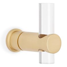 an image of a brass door handle on a white wall with clear glass and gold hardware