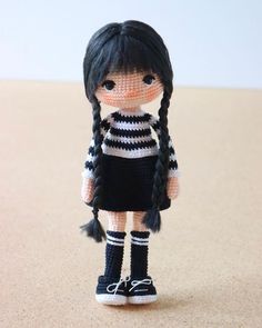 a doll with black and white stripes is standing on the floor