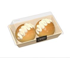 two donuts with white icing in a box on a white background, one is open and the other is closed