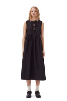 This Cotton Poplin Midi Dress is made from organic cotton. The dress is designed for a relaxed fit with an A-line silhouette and features a round neckline and three tie bands at the front. GANNI Black CottonPoplin Midi Dress in Black | Women's Size 10/12 Black Dress Layered Outfit, Midsummer Dresses, Black Poplin Dress, Artsy Streetwear, Neutral Closet, Front Tie Dress, Black Cotton Dress, Ganni Dress, Women Wearing Ties