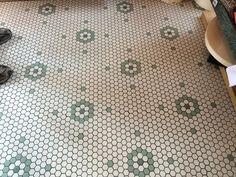 the bathroom floor is covered in green and white hexagonal tiles, which have been used as a pattern