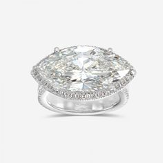 an oval cut diamond ring with pave diamonds on the shoulders and sides, set in 18k white gold