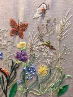 embroidery work with flowers and butterflies on fabric