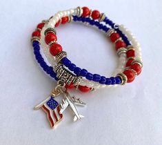 Introducing our Patriotic Wrap Bracelet, a captivating homage to freedom and adventure! Meticulously crafted, this bracelet showcases vibrant red, white, and blue beads, symbolizing the unity and pride of the American spirit. Adorned at its center are charming accents: a miniature airplane and an American flag charm, embodying the essence of patriotism and wanderlust. Wear this bracelet proudly on any occasion, adding a touch of patriotic elegance to your ensemble or gifting it to a fellow patriot. Order yours today and celebrate the land of the free and the home of the brave with sophistication and style! Red Round Beads Bracelets For 4th Of July, Blue Stretch Bracelet For 4th Of July Gift, Independence Day Red Beaded Bracelets, Patriotic Red Beaded Bracelet, Independence Day Red Beaded Bracelets With Round Beads, Red Beaded Bracelets For Independence Day, Patriotic Red Beaded Bracelet With Round Beads, Patriotic Multicolor Stretch Bracelet For 4th Of July, Patriotic Red Beaded Bracelets For Independence Day