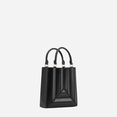 The new Sera Tall Tote is designed to carry your daily essentials, it can easily fit a large phone(like iPhone 13 Pro Max), mini wallet or cardholder, keys, lipstick, etc. Its exterior design is a surrealist dream, reminiscent of a maze-like structure protruding outwards, with sharp, clean lines, and a 3D façade. It ha Designer Top, Luggage Sizes, Drawstring Top, Secret Sale, Mini Wallet, New Launch, Square Bag, Handle Bag, Matte Gold