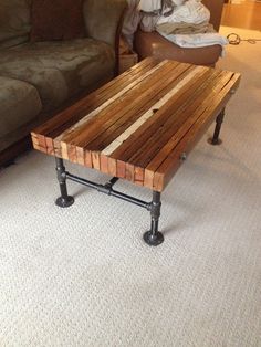 a coffee table made out of pallet wood and pipe legs in a living room