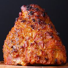 a large piece of meat sitting on top of a wooden cutting board