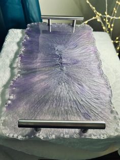 a piece of glass sitting on top of a white table next to a blue chair