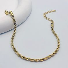 Crafted with meticulous attention to detail, this bracelet features a mesmerizing twisted chain design, adding a touch of glamour to any outfit. Whether you're dressing up for a special occasion or adding a chic accent to your everyday look, our bracelet is the perfect choice. Available in silver and gold Trendy Chain Bracelet With Lobster Clasp For Party, Elegant Bracelets With Rope Chain And Link Shape, Elegant Bracelets With Rope Chain Link, Elegant Bracelets With Link Rope Chain, Elegant Rope Chain Link Bracelets, Elegant Rope Chain Link Bracelet, Rope Chain Bracelet As A Gift, Twisted Chain, Mini Twists