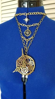 The Steampunk pocket watch pendant is hand made and one of a kind. It contains a 2 in brass ring, metal gears, clock hands, gold and silver wire and small link copper chain. It hangs on a necklace made from four different types and colors of chain to create that steampunk feel. It also features 14 karat gold plated compass rose, north star and arrow charms. Closes with a bronze lobster claw clasp. Please include your neck measurement in the comments at checkout so I can adjust it to fit. Steampunk Soldered Brass Jewelry, Gold Steampunk Nickel-free Jewelry, Handmade Steampunk Gold Jewelry, Gold Metal Pocket Watch Nickel Free, Nickel-free Gold Steampunk Jewelry, Gold Steampunk Metal Necklaces, Gold Steampunk Necklaces, Steampunk Gold Jewelry With Adjustable Chain, Gold Steampunk Round Pendant Jewelry