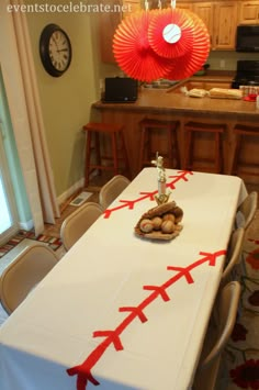 a white table with red arrows on it in the middle of a room filled with chairs