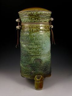 a large green vase sitting on top of a table