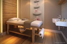 a spa room with two massage tables and towels