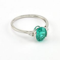 This 2 carat lab grown paraiba garnet 6x8mm oval shaped gemstone is set in a sterling silver setting with a rhodium finish. Gemstone has a brilliant concave cut so it sparkles. The rhodium finish protects the silver and makes for easy care. This ring is a size 7 and can be special ordered in another size. To clean: simple wash in a mild detergent like Dawn with a tooth brush. You do not want to put a rhodium plated piece of jewelry in any harsh chemicals. Style Number: 19151 Metal: 925 Sterling Silver Gemstone: Lab Grown Paraiba Garnet with Cubic Zirconia Accents Dimensions: 5/16 inch wide Oval Emerald Ring In 14k White Gold, Oval Emerald Promise Ring In 14k White Gold, Oval Emerald Ring In White Gold, Oval Brilliant Cut Emerald Ring As Gift, Oval Emerald Gemstone Ring In 14k White Gold, Oval Emerald Ring In Sterling Silver, 14k White Gold Oval Emerald Ring With Prong Setting, Oval Emerald Ring With Silver Center Stone, Formal Oval Emerald Ring In Sterling Silver