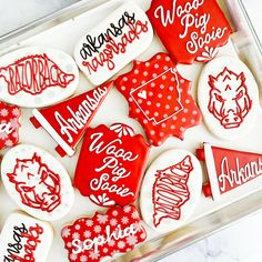 red and white decorated cookies in a box