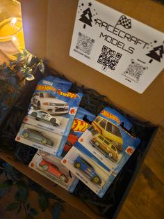 a box filled with toy cars sitting on top of a table