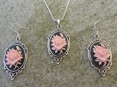 "For sale are beautiful flawless (pink rose with a single bud on a striking black background) cameo pendant necklace and matching earrings set The cameos are gorgeous, very detailed They are offered at a reasonable price, make perfect gifts, and are wonderful quality The cameo is set in an ornate tibetan silver setting, and the chain is 22\" .925 silver plated 1.2mm snake chain, with a lobster claw clasp The earrings match perfectly and the earring hooks are .925 silver plated and stamped Wonder Classic Rose-colored Formal Jewelry, Rose Classic Formal Jewelry, Classic Rose Design Jewelry For Gifts, Rose Oval Jewelry With Rose Design, Oval Rose Jewelry With Rose Design, Formal Rose-colored Sterling Silver Jewelry, Classic Pink Cabochon Jewelry, Victorian Rose Design Jewelry For Formal Occasions, Vintage Sterling Silver Jewelry With Rose Design