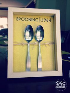 two spoons are in a shadow box with the words spooning since 1974 on it