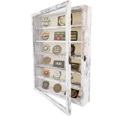 an old wooden display case filled with lots of different types of buttons and magnets