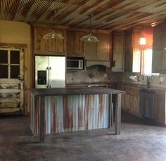 an empty kitchen with wooden cabinets and metal barstools on the counter top,