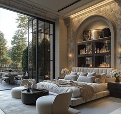 an elegant bedroom with large windows and white furniture