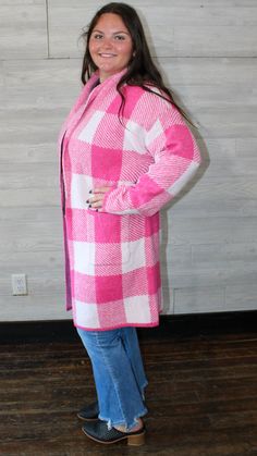 A pink long cardigan with a checkered design on it. This will keep you warm in the up-coming fall/ winter season. Fit: true to size Small: 2-4 Medium: 6-8 Large: 10-12 Model: medium Laundry: wash on cold, hang to dry Pink Sweater For Fall Cold Weather, Pink Sweater For Cold Weather In Fall, Cozy Plaid Sweater For Spring, Pink Spring Sweater For Cold Weather, Pink Sweater For Cold Spring Weather, Pink Sweater For Spring Cold Weather, Pink Casual Cardigan For Cold Weather, Casual Pink Cardigan For Cold Weather, Cozy Pink Cardigan For Cold Weather