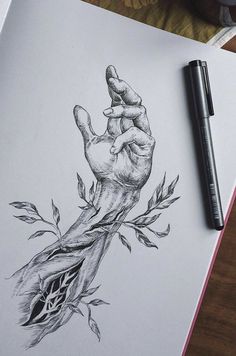 a drawing of a hand holding a plant on top of a piece of paper next to a pen