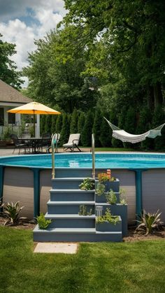 an above ground swimming pool with steps leading up to it and a hammock in the background