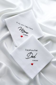 two embroidered napkins with hearts on them that say, i loved you first and dad