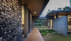 a house with stone walls and wooden walkway